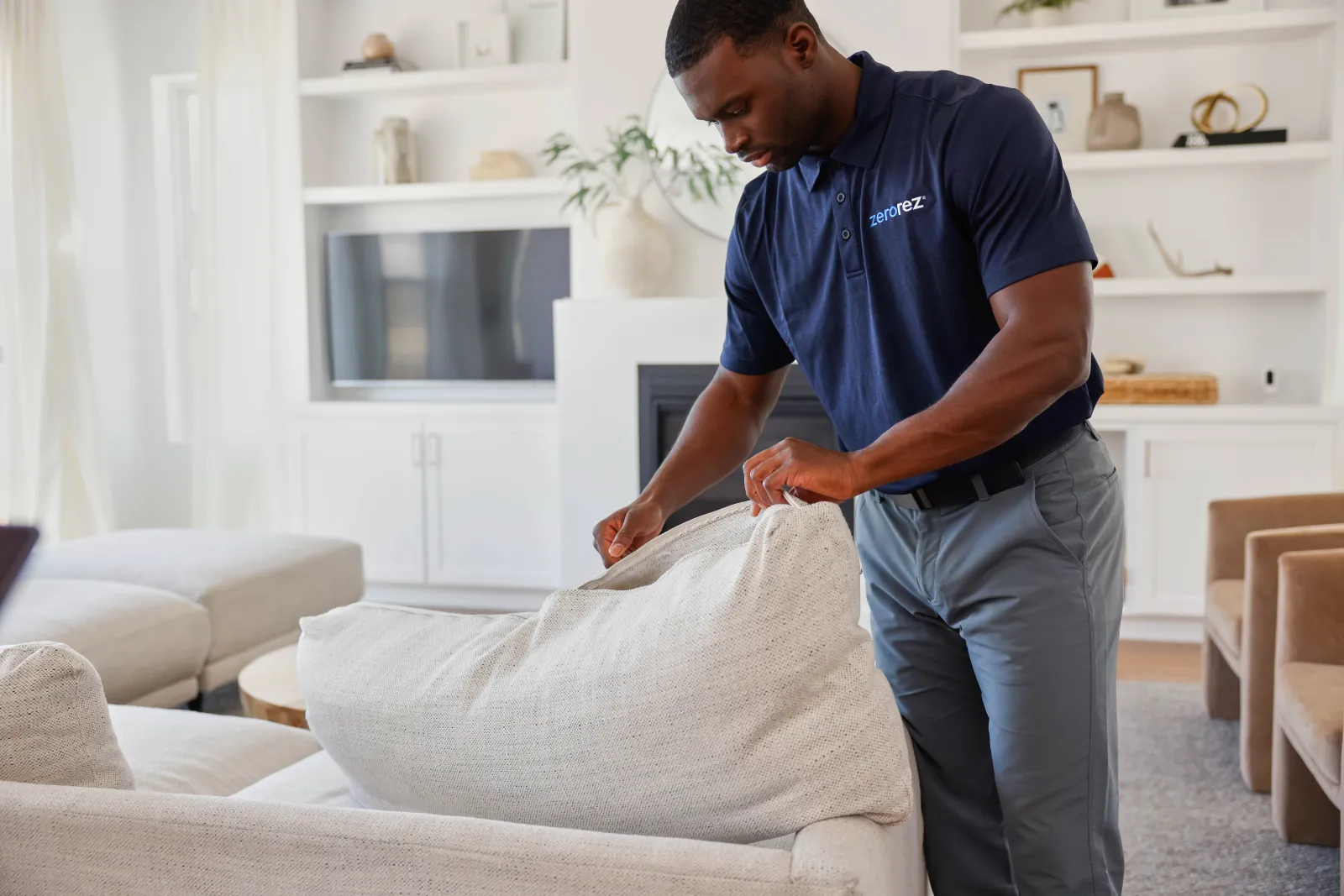 zerorez technician inspecting a cream sofa