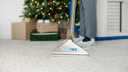 a man holding a vacuum cleaner