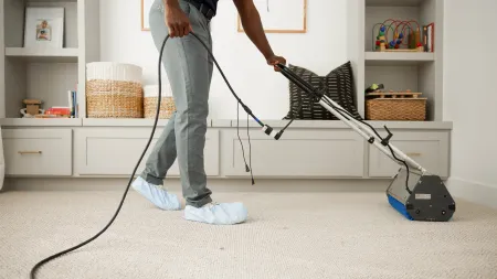 a person holding a vacuum cleaner