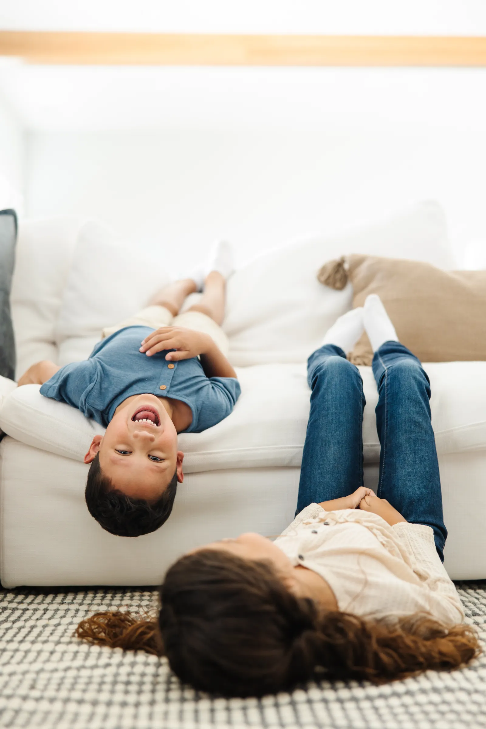 kid playing on couch and on the floor