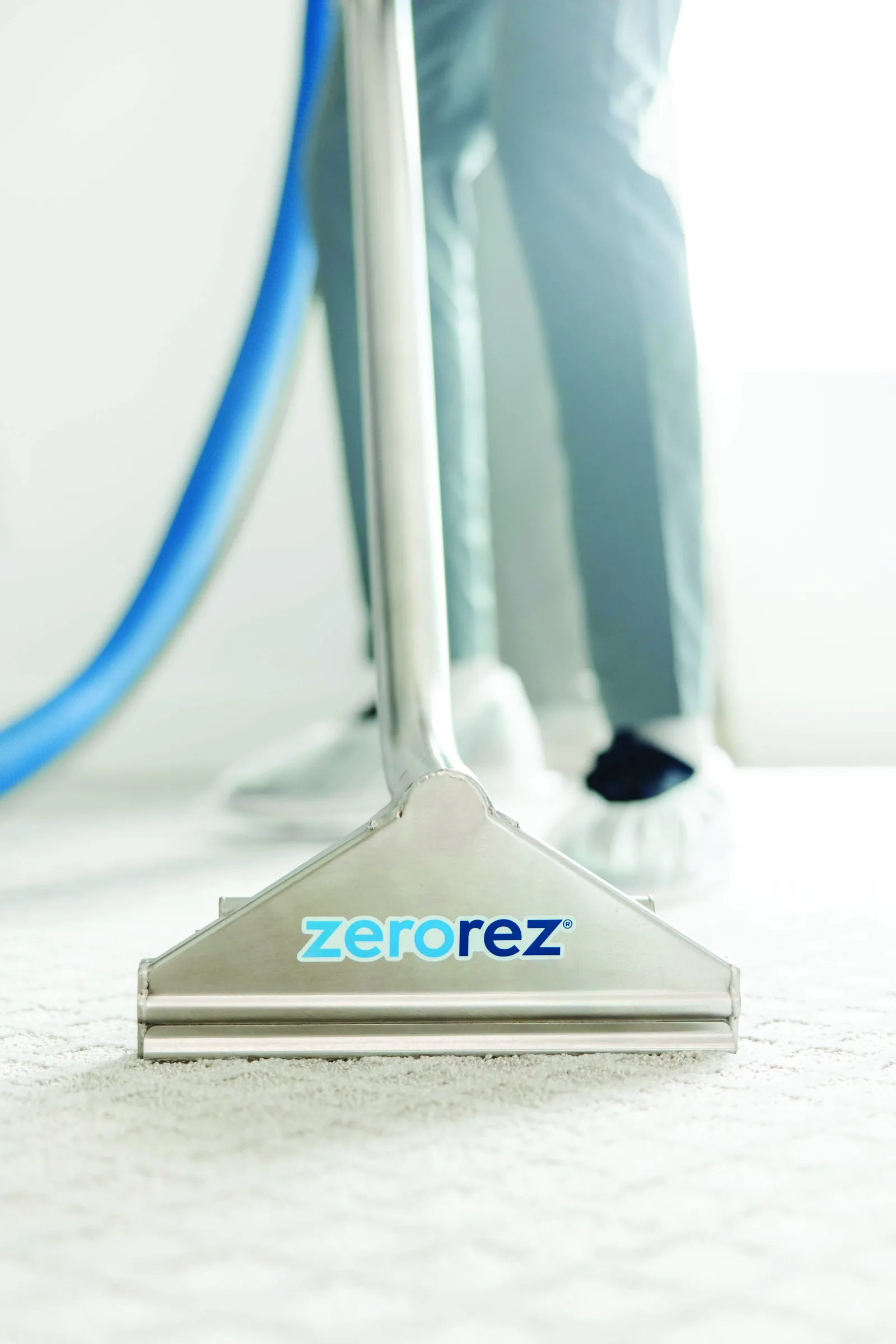 steam cleaning wand on cream carpet