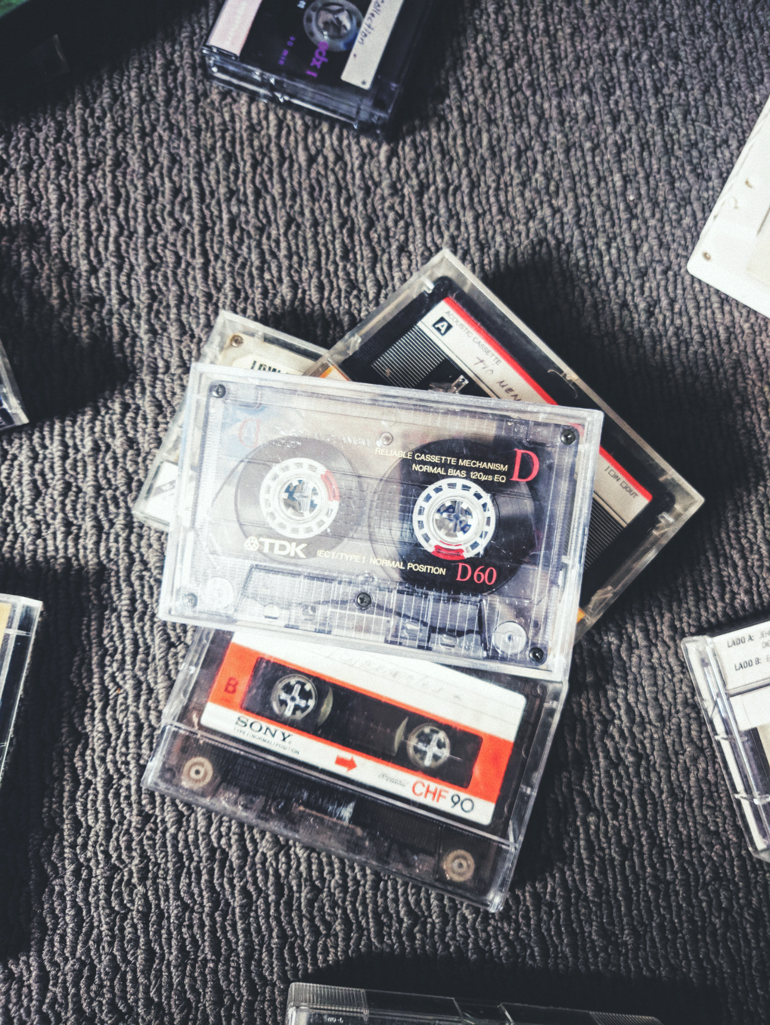 old cassett tapes of music lying on a berber carpet begging the question if Berber carpet is out of style